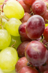This is a photograph of Green and Red Grapes isolated on a White background