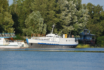 Motor ship at small river harbor