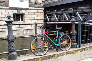 Fototapeta na wymiar BERLIN, GERMANY - May 15, 2014. Broken forgotten bicycle on the bridge in Berlin.