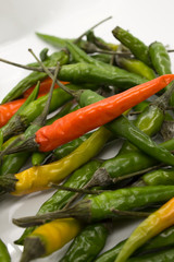 This is a photograph of Thai Chili peppers isolated on a White background