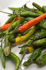 This is a photograph of Thai Chili peppers isolated on a White background