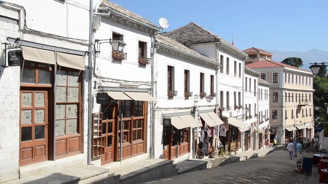 Old quarters of Gjirokast&euml;r, Albania. Traditional houses, shops and tourists in old city. UNESCO World Heritage Site. Historical buildings, architecture and cultural heritage. Gjirokaster.