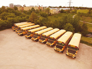 The parking lot full of yellow school buses waiting for educational season. Row filled with many...