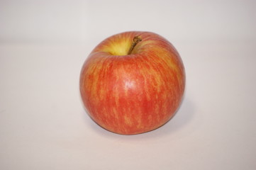 red apple on a white background. with a small ponytail.