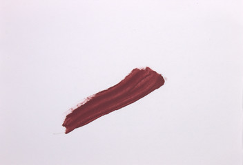 This is a photograph of a Brown Lipstick swatch isolated on a White background