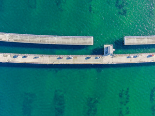 Aerial top view of pier with parked car in the ocean, Tampa Bay Florida, USA.
