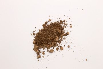 This is a photograph of a Brown powder eyeshadow isolated on a White background