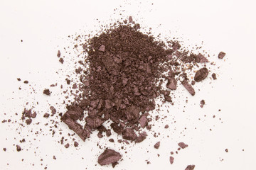 This is a photograph of a Dark Purple powder Eyeshadow isolated on a White background