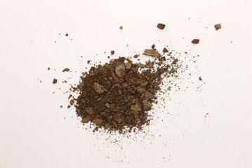 This is a photograph of a Dark Brown powder Eyeshadow isolated on a White background