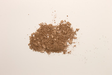 This is a photograph of a Copper powder Eyeshadow isolated on a White background