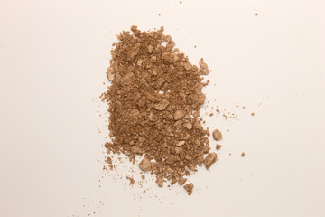 This is a photograph of a Copper powder Eyeshadow isolated on a White background