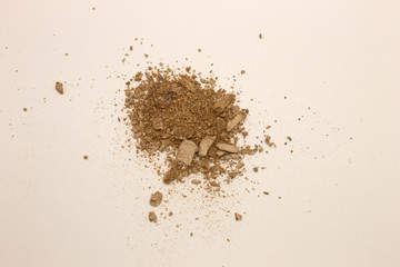 This is a photograph of pale Taupe powder Eyeshadow isolated on a White background