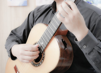 The man is playing guitar