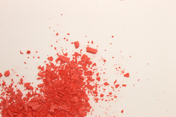 This is a photograph of Orange powder Blusher isolated on a White background