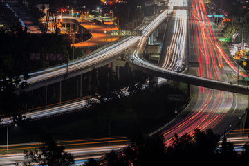 Night view of commuters on Route 134 and Interstate 5 Freeway interchange ramps near Los Angeles,...