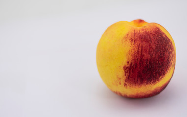Ripe bicolor peach, yellow and reddish, ripe
