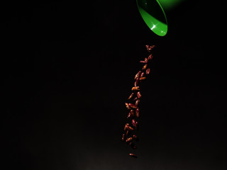 beans falling from a green cup