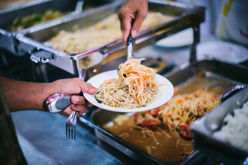 Providing free food for the poor to fill their stomachs and alleviate hunger : concept of feeding, helping and sharing