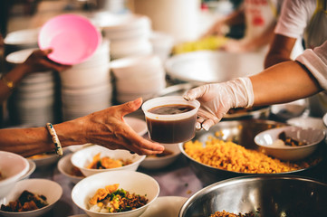 Providing free food for the poor to fill their stomachs and alleviate hunger : concept of feeding, helping and sharing