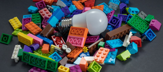 Bulb light in middle of toys blocks in a black background