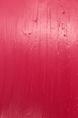 This is a photograph of a Vibrant Pink Lipstick swatch background