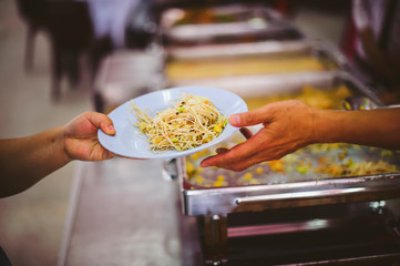 Volunteers give away free food to hungry people : concept of care And feeding
