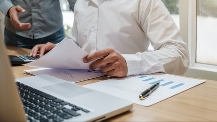 Business team brainstorming and discussing with financial data and report graph. Teamwork meeting working concept.