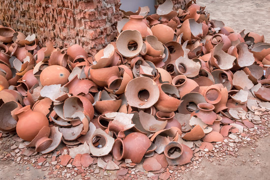 Pile of broken clay pots or earthenware or traditional jar on a abandoned road.