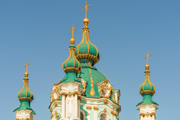 Fototapeta na wymiar Domes of St. Andrew's Church, designed by architect Rastrelli, Kiev, Ukraine, sunny autumn day.