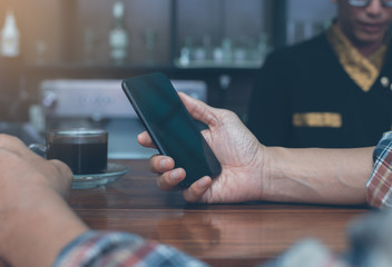 Man using smartphone at coffee shop