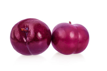 red cherry plum with green leaves isolated on white background