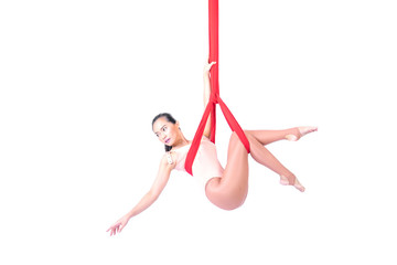 Beautiful woman Asian sport girl fly yoga posing on a red hammock isolated white background , Aerialist gymnastics performs physical exercises - yoga concept
