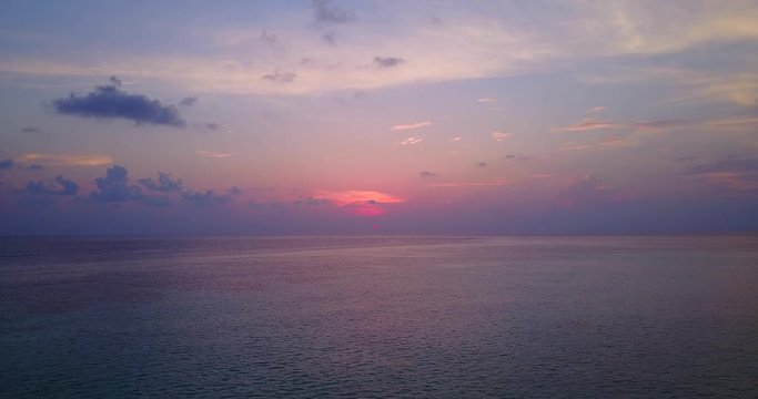 Static view of fabulous sunset with red violet colors, endless ocean pan, near Three Kings Islands