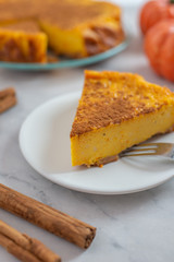 home made pumpkin cheesecake with cinnamon crust on a plate