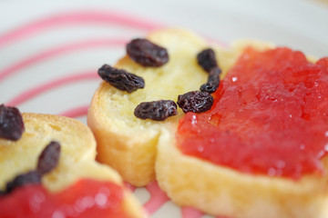 Toast and strawberry jam with currant , smile face toast