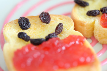 Toast and strawberry jam with currant , smile face toast