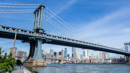 New York, NY, USA. Views of the Manhattan bridge from the historic and trendy Dumbo neighborhood. Wonderful summer day. Holiday time