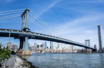 Fototapeta na wymiar New York, NY, USA. Views of the Manhattan bridge from the historic and trendy Dumbo neighborhood. Wonderful summer day. Holiday time