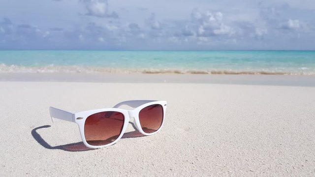 white sunglasses on sand of Philippines, still ground level shot
