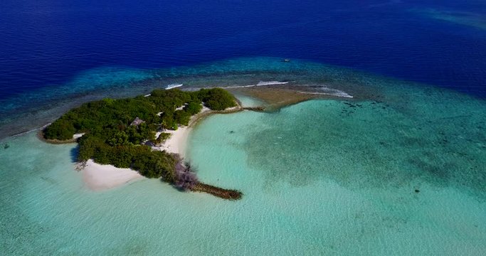 Astonishing view from very high of an isolated tropical island, turquoise lagoon and deep blue sea water in Chagos Archipelago