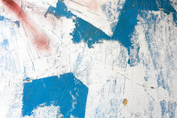 Rough colorful brushes on a white roughly painted wall. Blue brushes on a white wall.