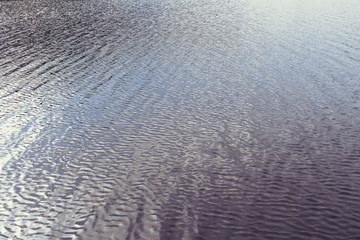 Wavy water surface of lake or river ripple background