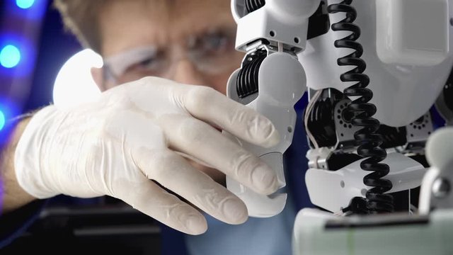 Engineer working in laboratory with the robot mechanism.