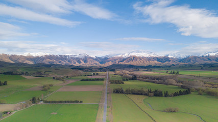 Amazing aerial view of green field with snowcap mountain in background.Aerial Panoramic view of Mount Cook in New Zealand.