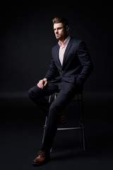 young man in suit. man with a beard. Male portrait on a black background. Stylish man. black and white photo. male model. studio portrait. Guy in a classic suit