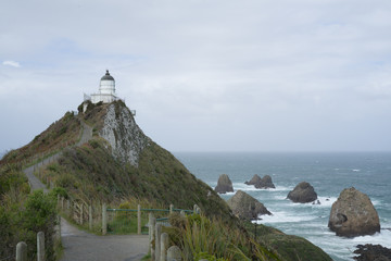 Fototapeta na wymiar Nugget Point Light House in sunny day.Beautiful view toward Nugget Point in New Zealand.