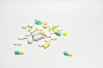 Tablets are white, yellow, green, put on a white background.