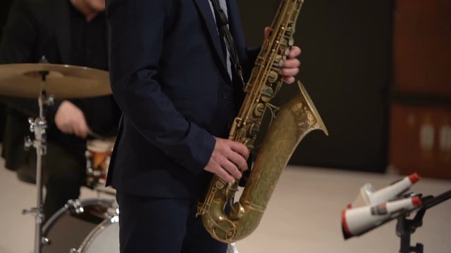 Jazz musician plays the saxophone in a band