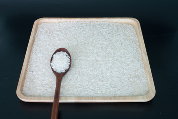 isolated jasmine rice on wood tray