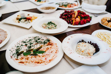 Served table with food. Plates with dishes on the table. The beginning of the holiday. Festive table in the restaurant. Side view.